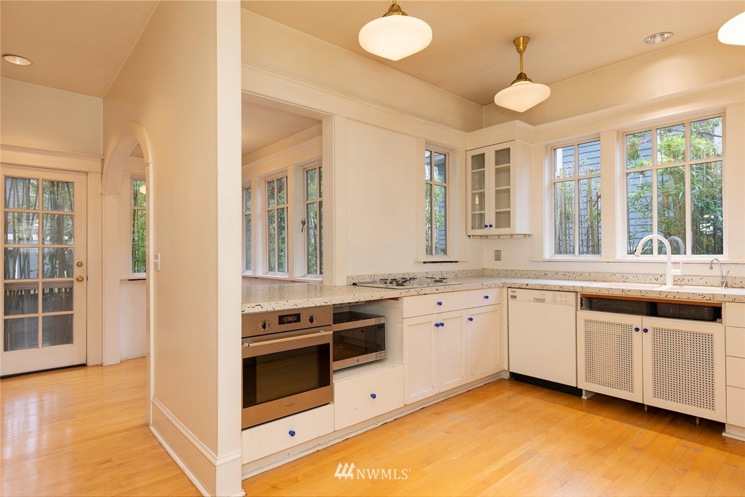 4233 Meridian Avenue North Seattle, WA 98103 - Photo 16 of 40 a kitchen with stainless steel appliances granite countertop a stove and a sink