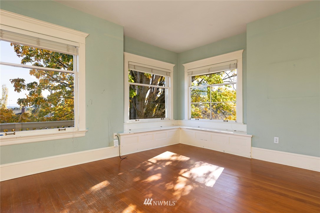 4233 Meridian Avenue North Seattle, WA 98103 - Photo 23 of 40 an empty room with wooden floor and windows
