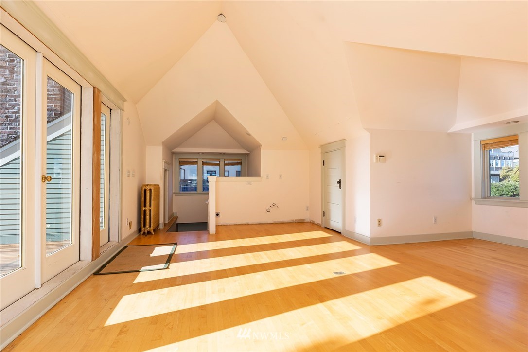 4233 Meridian Avenue North Seattle, WA 98103 - Photo 30 of 40 a view of a livingroom with wooden floor and a fireplace