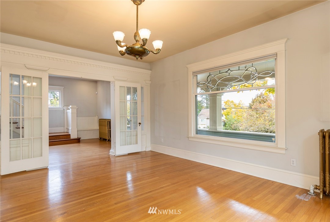 4233 Meridian Avenue North Seattle, WA 98103 - Photo 8 of 40 a view of an empty room with wooden floor and a window