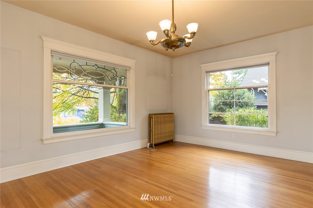 4233 Meridian Avenue North Seattle, WA 98103 - Photo 9 of 40 a view of an empty room with wooden floor and a window