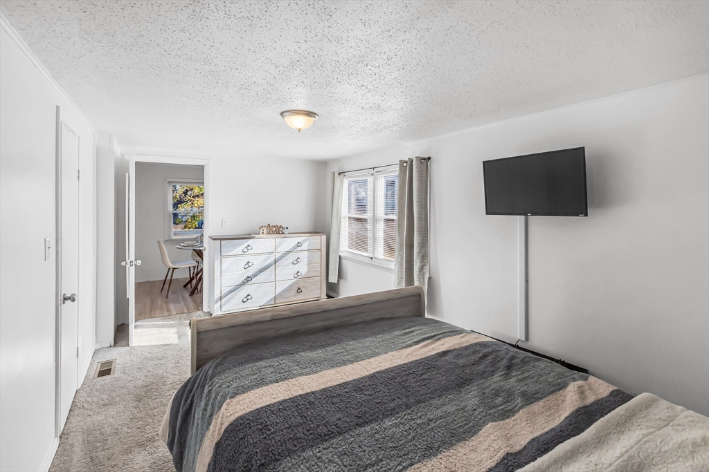 428 Page Boulevard Springfield, MA 01104 - Photo 27 of 40 a bedroom with a bed and a flat screen tv