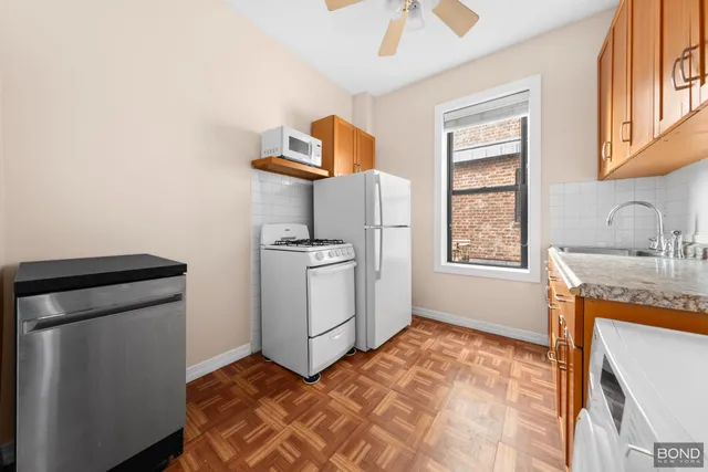 a kitchen with sink cabinets and window