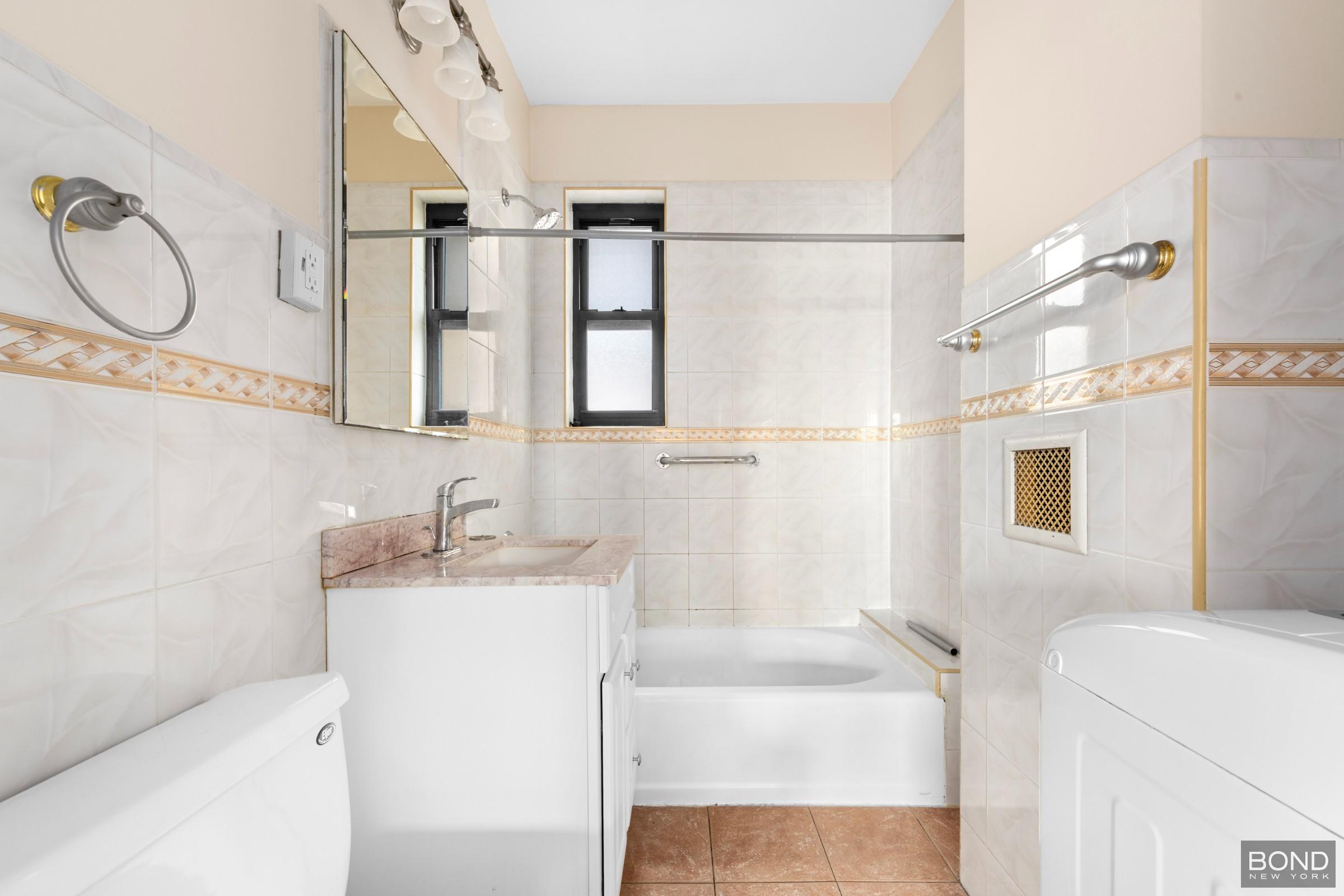 84-02 Beverly Road, Unit 2D Queens, NY 11415 - Photo 5 of 9 a bathroom with a sink toilet and shower