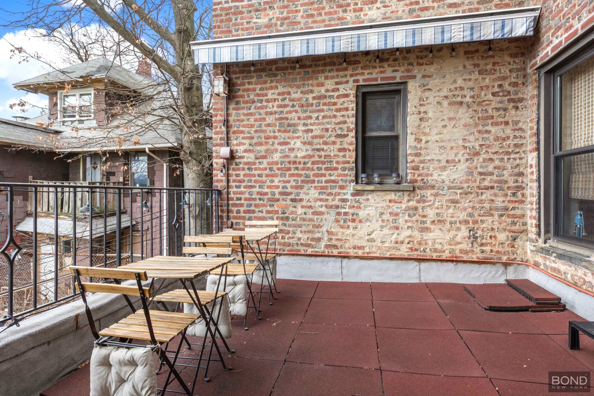 84-02 Beverly Road, Unit 2D Queens, NY 11415 - Photo 6 of 9 a view of a patio with a table and chairs