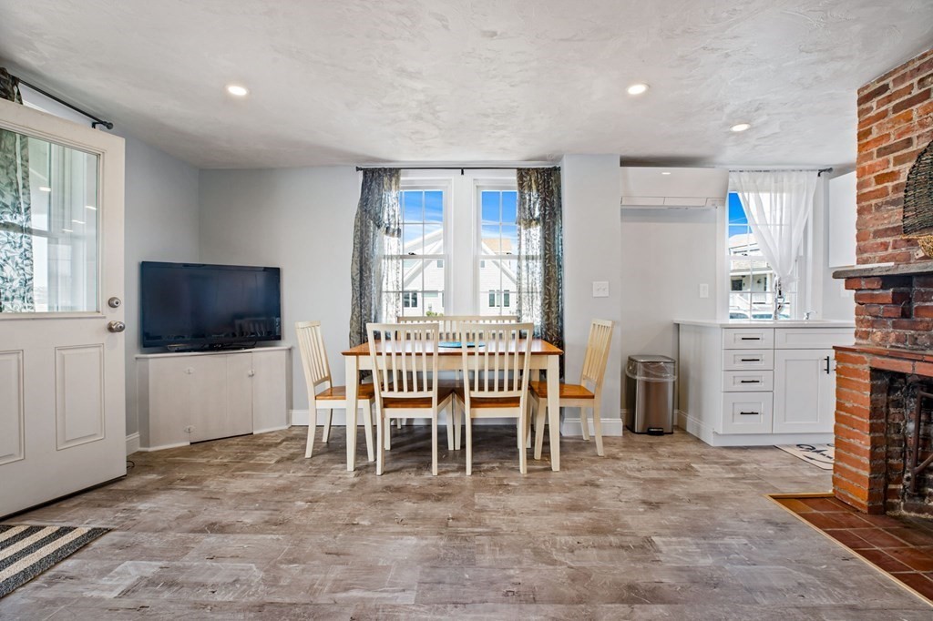 64 Lighthouse Road Scituate, MA 02066 - Photo 11 of 23 a dining room with furniture and a flat screen tv