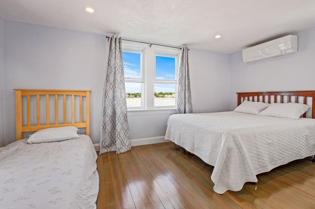 64 Lighthouse Road Scituate, MA 02066 - Photo 12 of 23 a bedroom with a bed and wooden floor