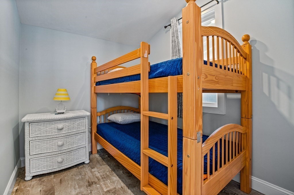 64 Lighthouse Road Scituate, MA 02066 - Photo 14 of 23 a bedroom with a bunk bed and a dresser