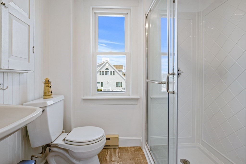 64 Lighthouse Road Scituate, MA 02066 - Photo 15 of 23 a white toilet sitting next to a bathroom sink