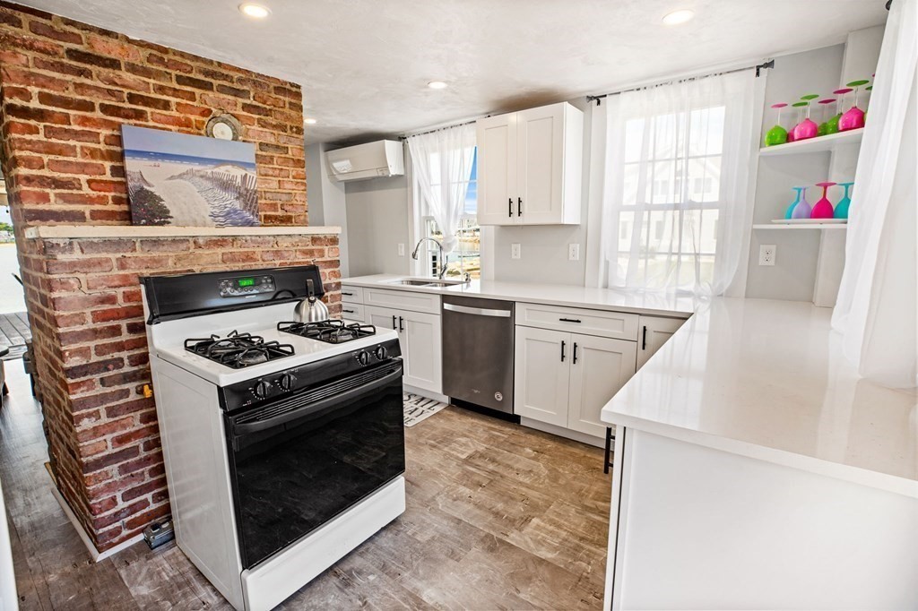 64 Lighthouse Road Scituate, MA 02066 - Photo 3 of 23 a kitchen with a stove top oven sink and cabinets