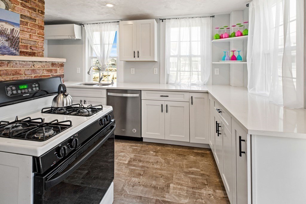 64 Lighthouse Road Scituate, MA 02066 - Photo 4 of 23 a kitchen with a stove a sink and a refrigerator