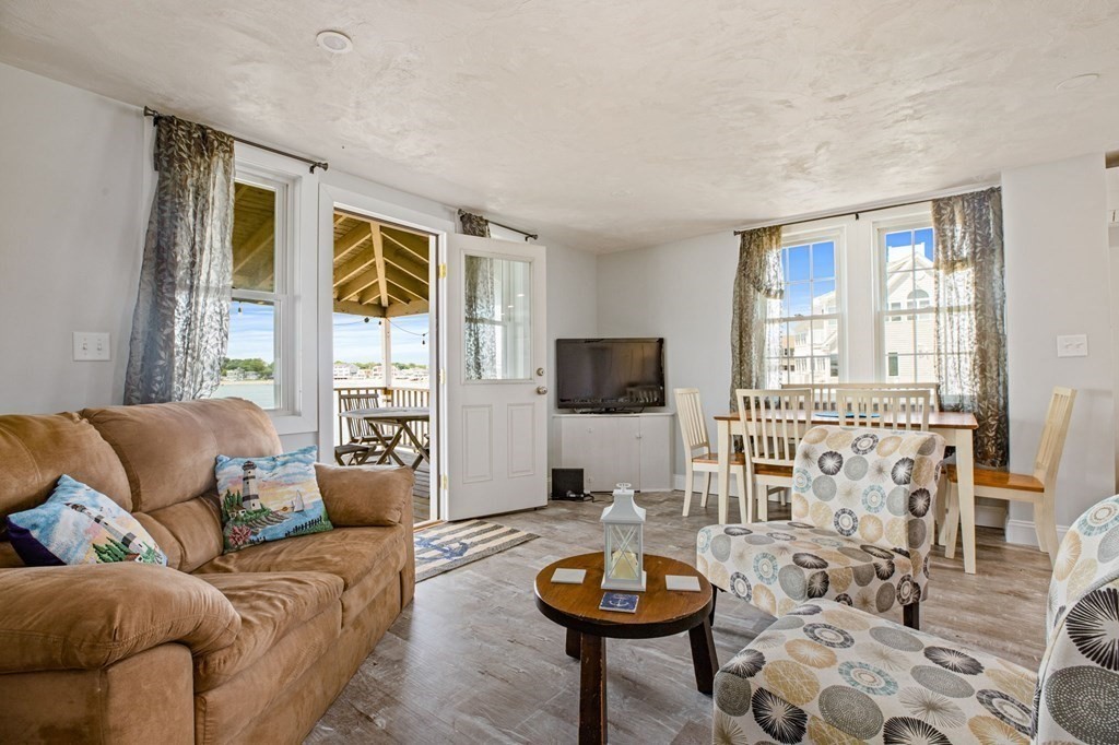64 Lighthouse Road Scituate, MA 02066 - Photo 9 of 23 a living room with furniture and a large window