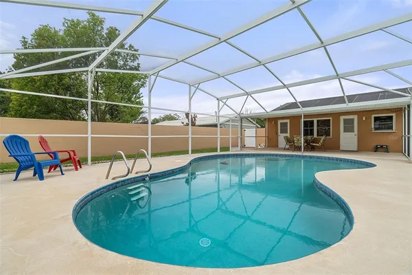 a view of a house with a backyard