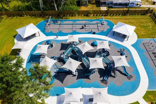 aerial view of a swimming pool with outdoor seating and yard
