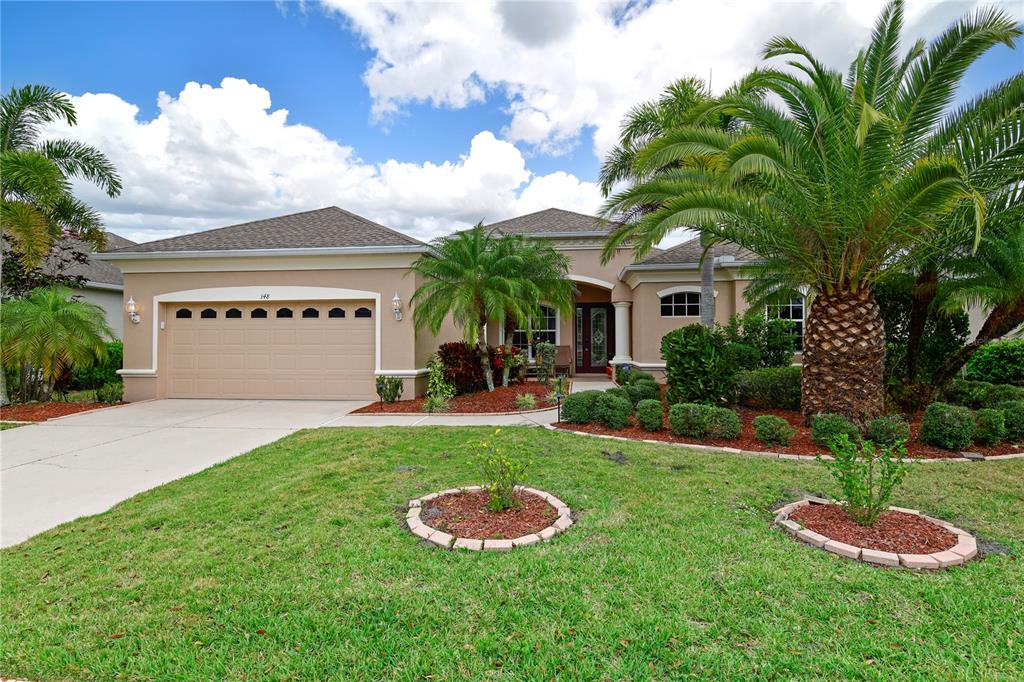 a front view of a house with a yard and garage