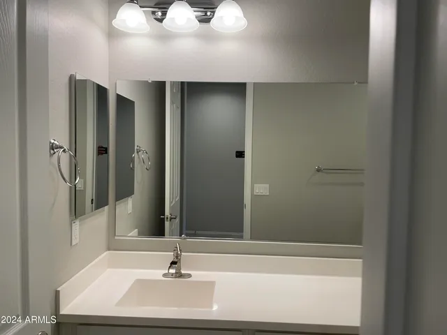 a bathroom with a sink a toilet and vanity