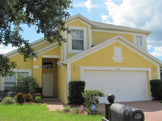 a view of house with yard and outdoor seating