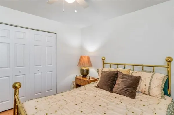 a bed sitting in a bedroom next to a lamp