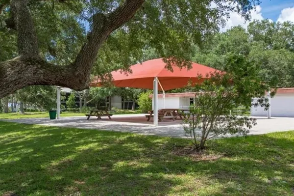a view of a house with a yard and sitting area