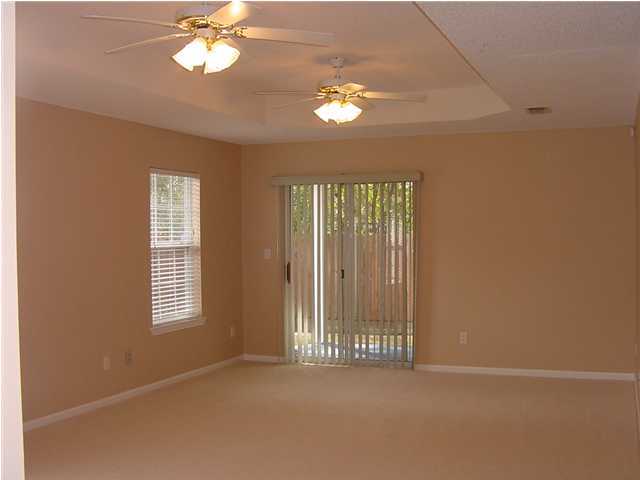1752 Old Ranch Road Fort Walton Beach, FL 32547 - Photo 20 of 23 en empty room with windows and chandelier fan