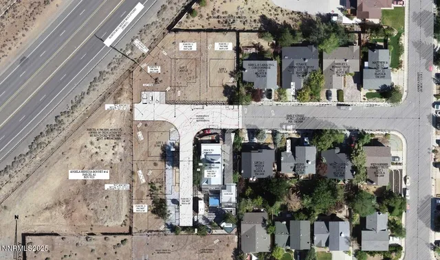 an aerial view of a house with a yard and a large window