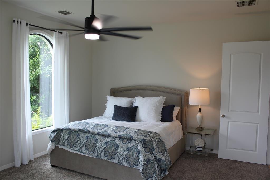 333 Renaissance Lane Heath, TX 75032 - Photo 30 of 35 Arched window with natural light, plush carpet flooring, and a contemporary ceiling fan with integrated lighting