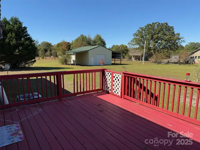 a view of wooden deck with a yard