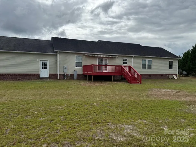 a view of a house with a garden and deck