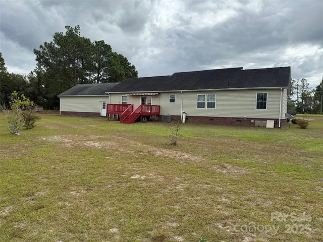 a view of a house with a yard and a garage