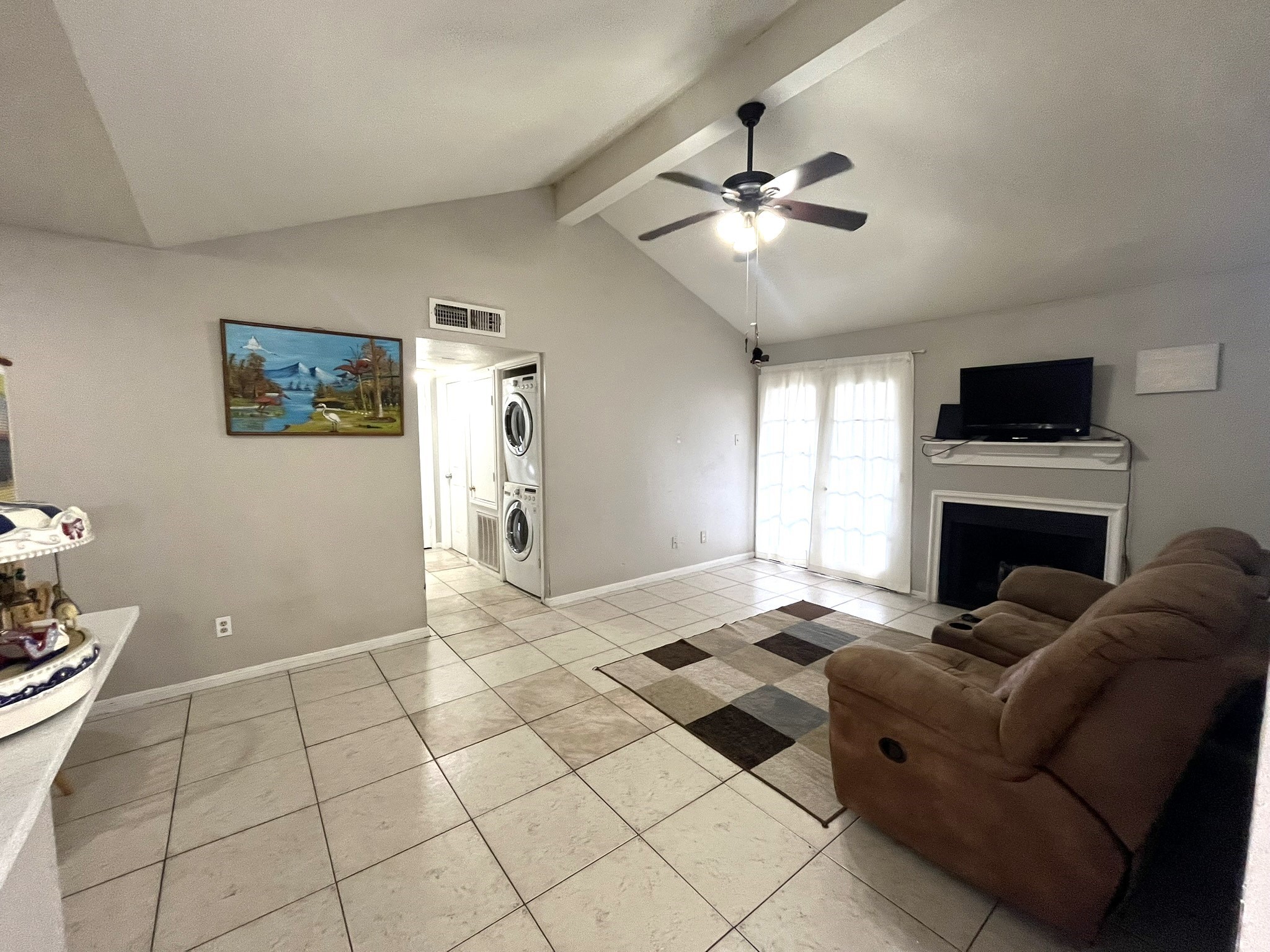 a living room with furniture and a fireplace