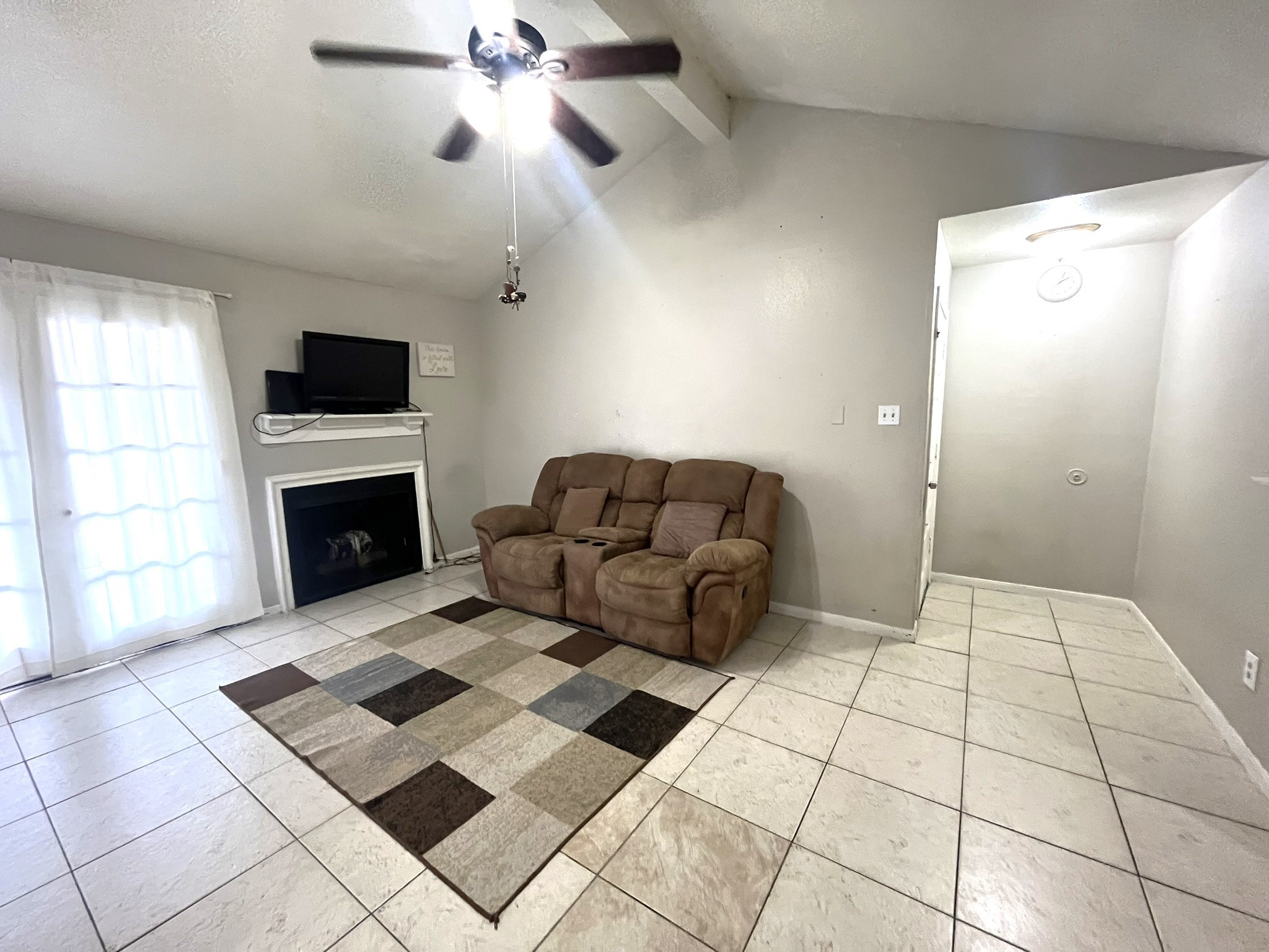 10211 Sugar Branch Drive, Unit 434 Houston, TX 77036 - Photo 2 of 13 a living room with a couch and a fireplace