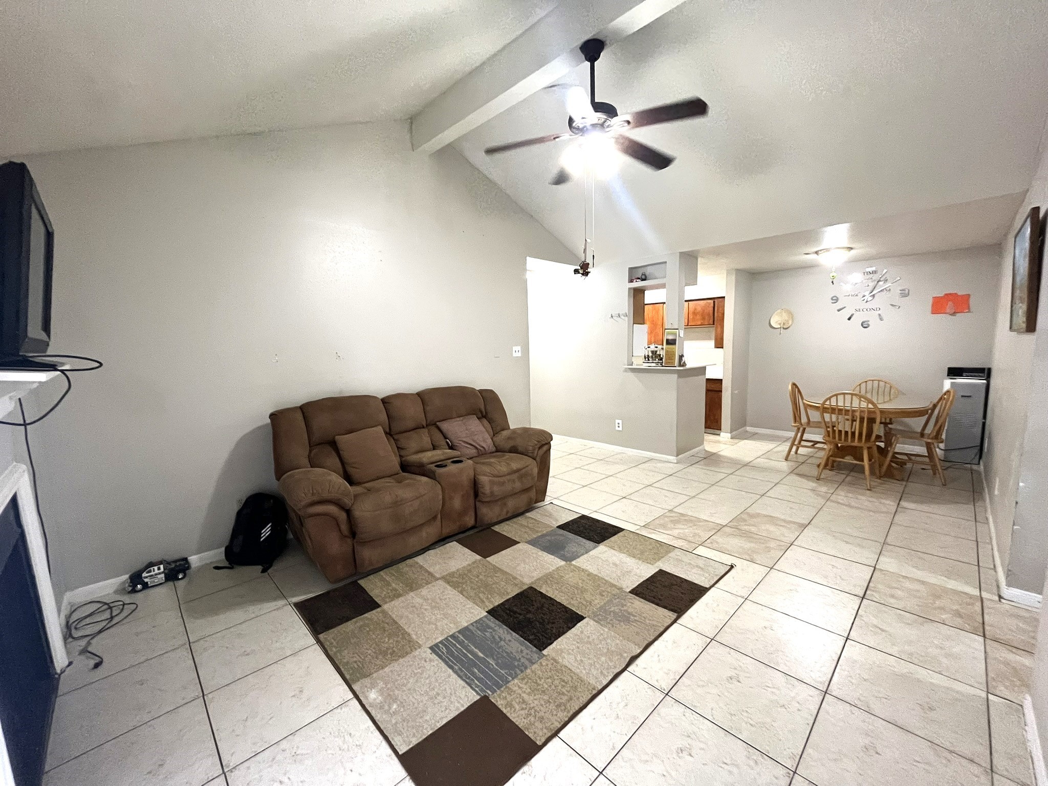 10211 Sugar Branch Drive, Unit 434 Houston, TX 77036 - Photo 3 of 13 a living room with a black white checkered floor with couches and a dining table with wooden floor