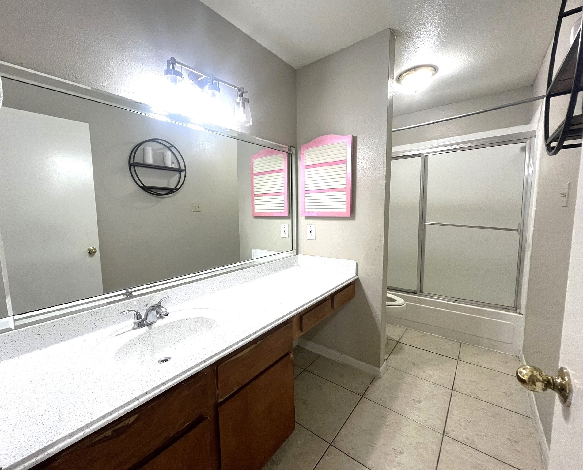 10211 Sugar Branch Drive, Unit 434 Houston, TX 77036 - Photo 10 of 13 a bathroom with a sink a toilet a mirror and a shower
