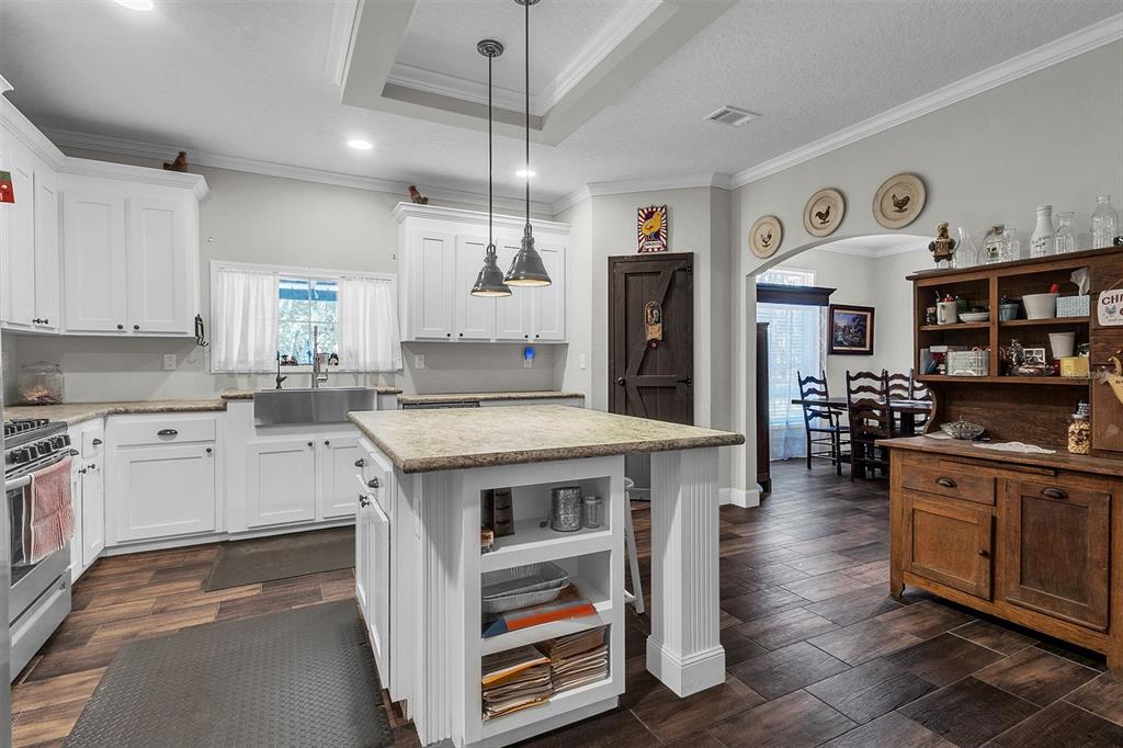 601 Purvis Road Seville, FL 32190 - Photo 14 of 29 a kitchen with stainless steel appliances granite countertop a stove and cabinets