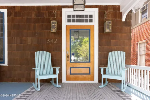 a view of living room with furniture and large windows