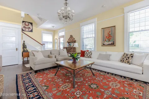 a dining room with furniture and wooden floor