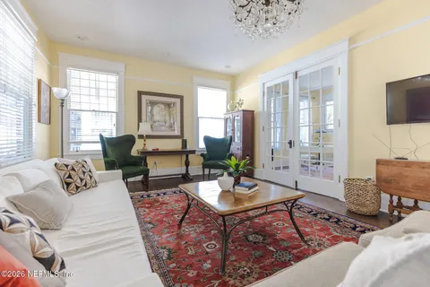 a dining room with furniture and chandelier