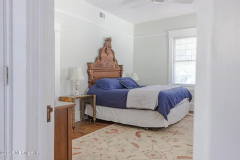 a view of a bedroom with furniture and a window