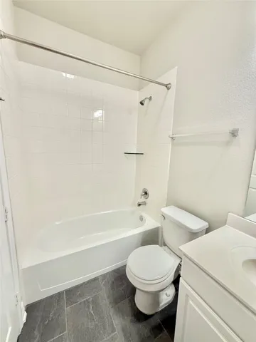 a bathroom with a toilet and a bathtub