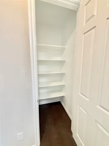 a view of walk in closet with empty racks