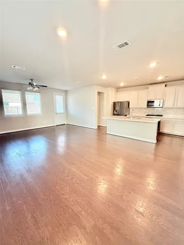 a view of a kitchen with a sink and a stove top oven