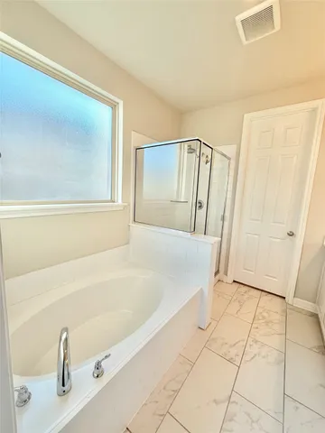a bathroom with a bathtub and shower