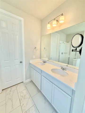 a spacious bathroom with a mirror a sink and a mirror