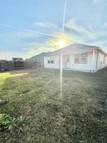 a view of a house with a yard and a garage