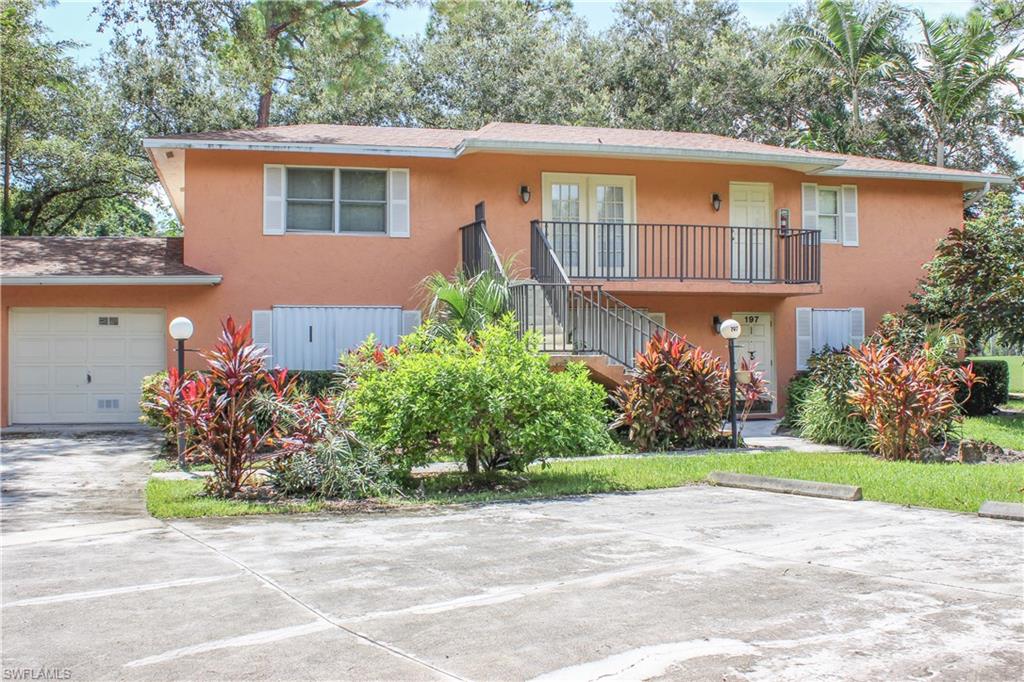 a front view of a house with a yard and a garage
