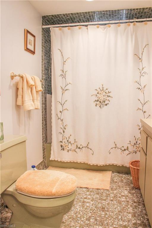 197 Albi Road, Unit 202 Naples, FL 34112 - Photo 9 of 12 a bathroom with a bathtub and shower