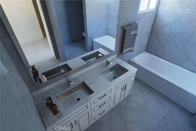 a bathroom with a double vanity sink a toilet and bathtub