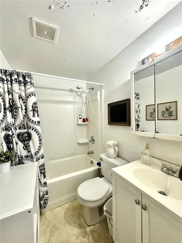 a bathroom with a sink toilet a mirror and shower