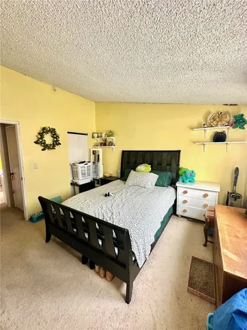 a bedroom with a bed and a night stand