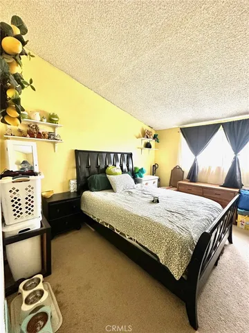 a bedroom with a bed and a night stand